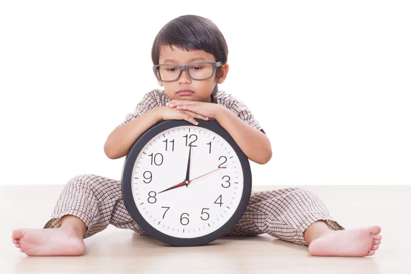 Cute boy is holding big clock Royalty Free Stock Photos