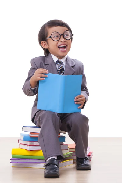 Cute boy in suit reading a book — Stock Photo, Image