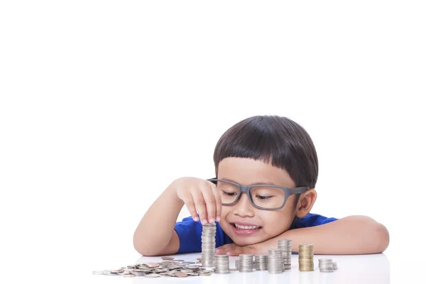 Cute boy with a stack of coins — Stock Photo, Image