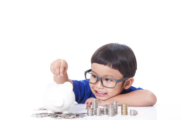 Cute boy saving money in piggy bank — Stock Photo, Image