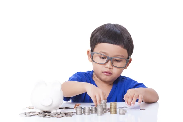 Cute boy saving money in piggy bank — Stock Photo, Image