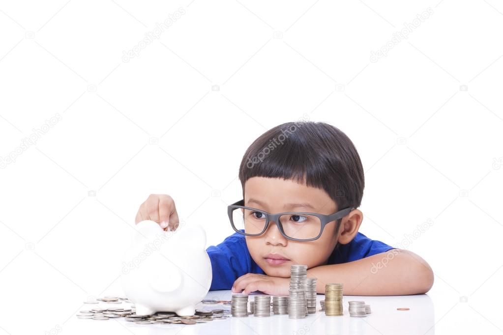 Cute boy saving money in piggy bank