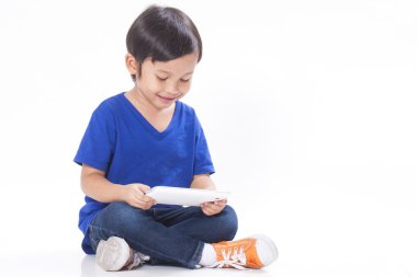 Cute boy playing a game on computer tablet clipart