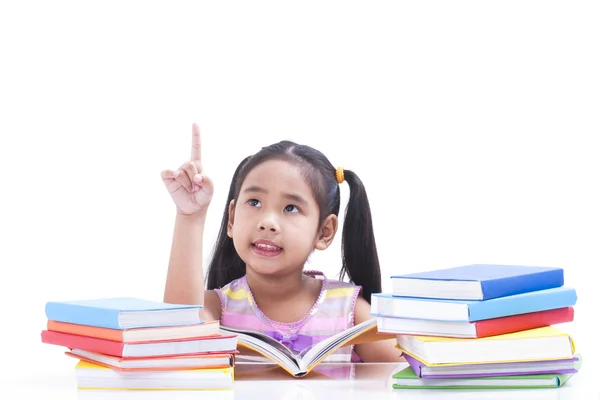Little girl is reading book and pointing up. — Stock Photo, Image