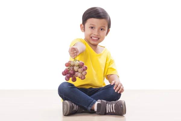 Cute boy with grapes — Stock Photo, Image