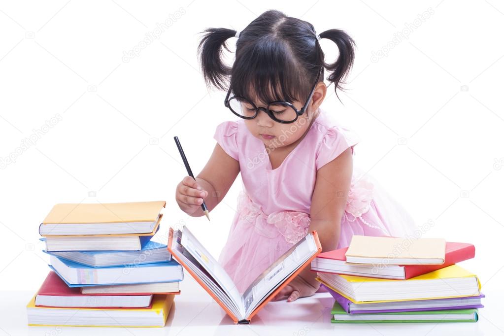 little girl writing in book