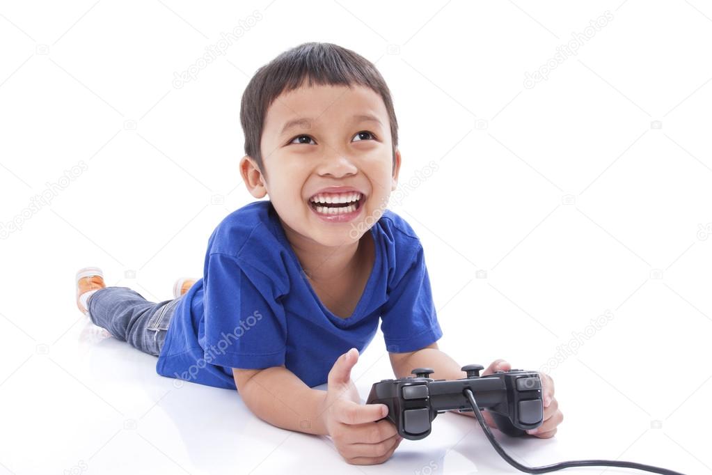 Boy playing video game and lying on the floor