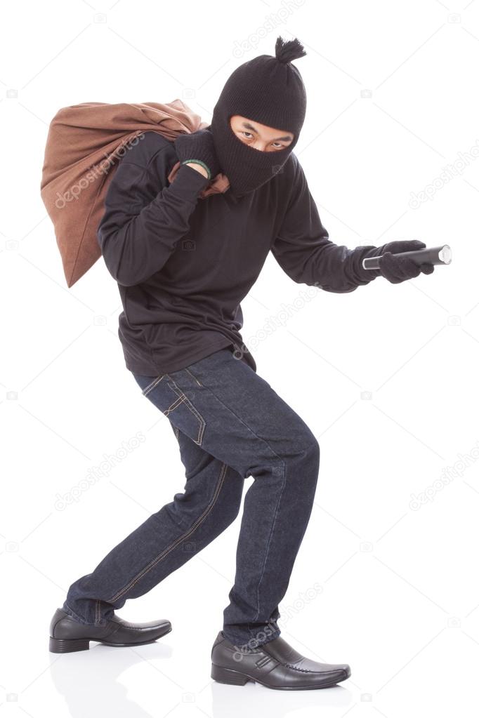 Thief with bag and holding flashlight
