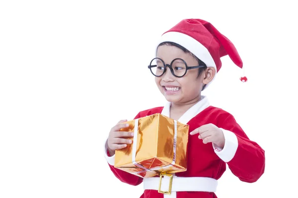 Little boy wearing Santa Claus uniform with gifts — Stock Photo, Image