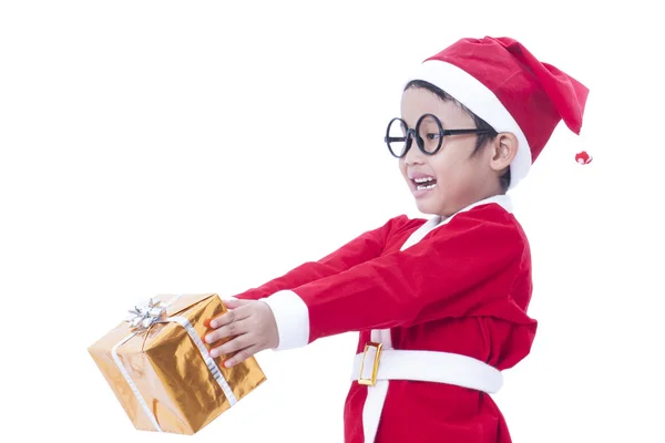 Little boy wearing Santa Claus uniform with gifts — Stock Photo, Image