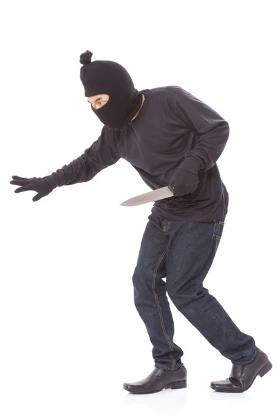 Man in a mask with a knife — Stock Photo, Image