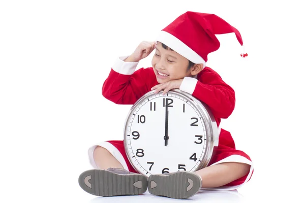 Happy boy holding a big clock at christmas — Stock Photo, Image