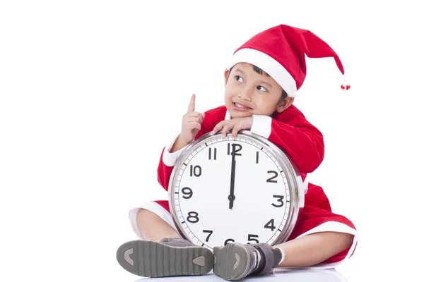 Happy boy holding a big clock at christmas — Stock Photo, Image