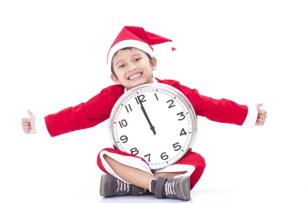 Happy boy holding a big clock at christmas — Stock Photo, Image