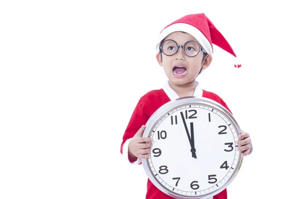 Happy boy holding a big clock at christmas — Stock Photo, Image