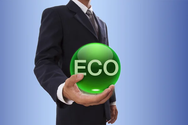 Geschäftsmann hält grüne Kristallkugel mit Ökowort in der Hand. — Stockfoto