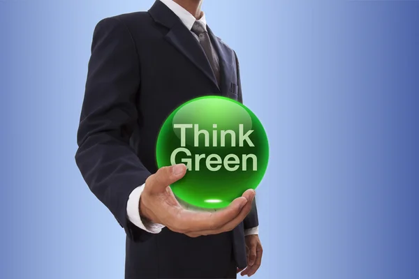 Üzletember kezében kék kristálygömb, gondolom, zöld szó. — Stock Fotó