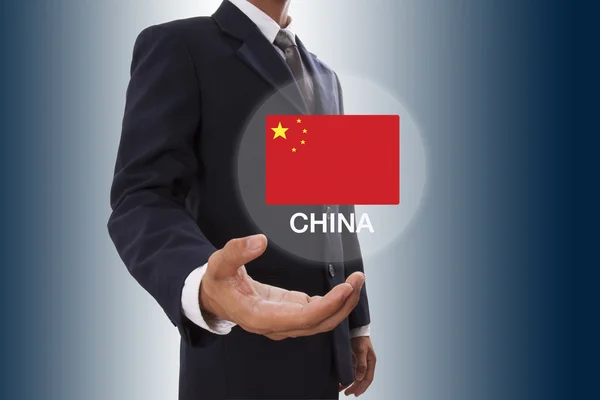 Podnikatel ruka ukazuje Čína vlajky — Stock fotografie