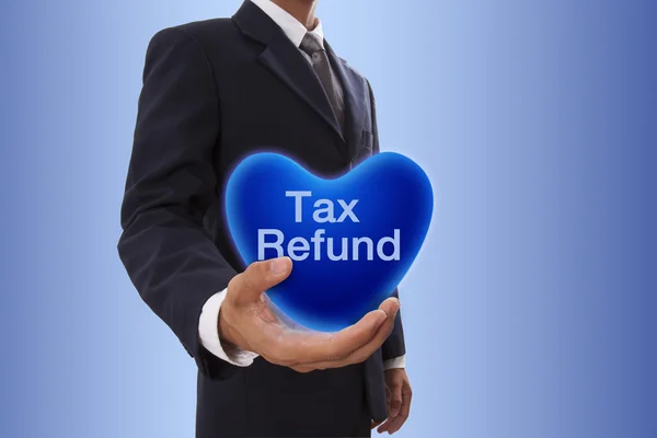 Podnikatel ruka drží modré srdce bublina s slovo refundace daně — Stock fotografie