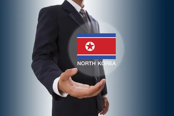 Empresario mano mostrando bandera de Corea del Norte —  Fotos de Stock