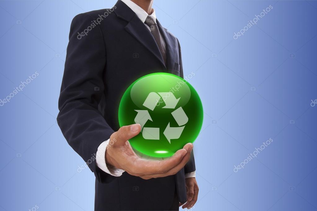 Businessman hand holding green crystal ball with recycle logo.