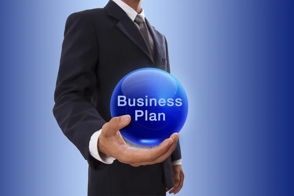 Businessman hand holding blue crystal ball with business plan word. — Stock Photo, Image