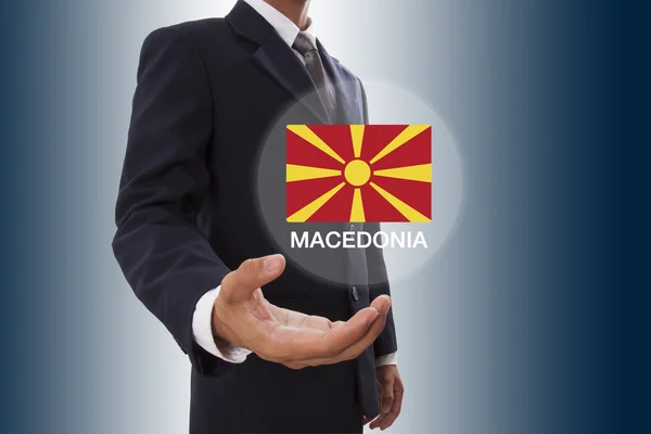 Empresario mano mostrando bandera de Macedonia — Foto de Stock