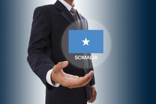 Usinessman mano mostrando la bandera de Somalia —  Fotos de Stock