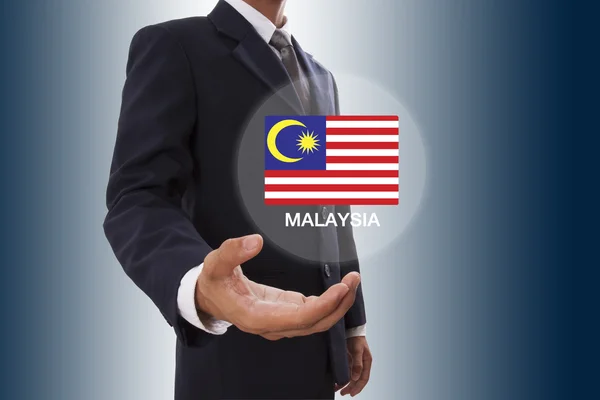 Χέρι επιχειρηματίας με τη σημαία της Μαλαισίας — Φωτογραφία Αρχείου