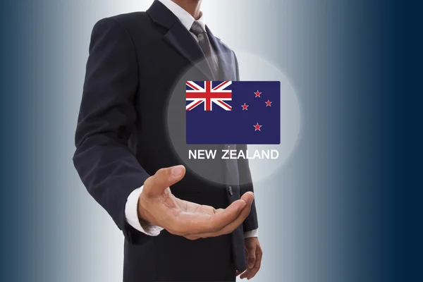 Businessman hand showing New Zealand Flag — Stock Photo, Image