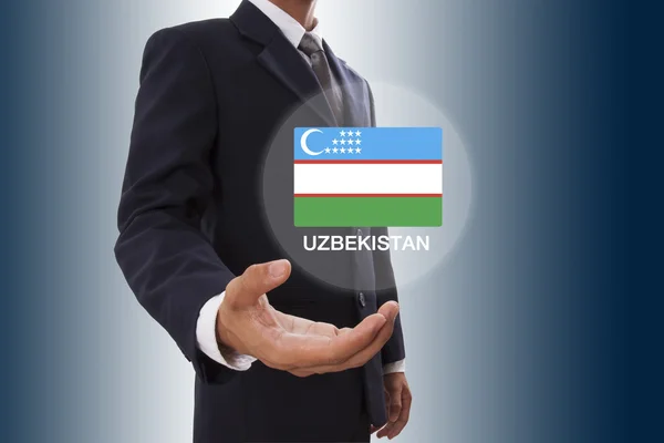 Businessman hand showing Uzbekistan Flag — Stock Photo, Image