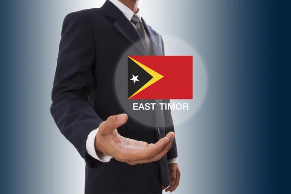 Empresario mano mostrando bandera de Timor Oriental — Foto de Stock