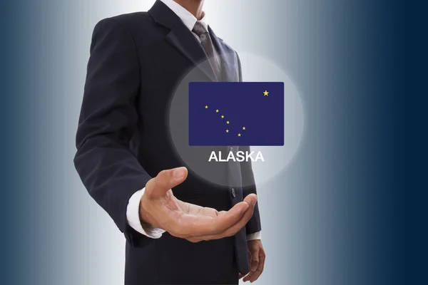 Businessman hand showing Alaska Flag — Stock Photo, Image