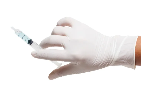 Someone wearing medical gloves holding a syringe — Stockfoto