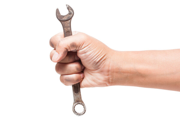 Hand holding a spanner isolated