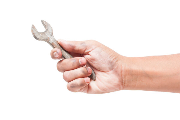 Hand holding a spanner isolated