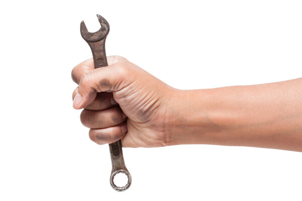 Hand holding a spanner isolated