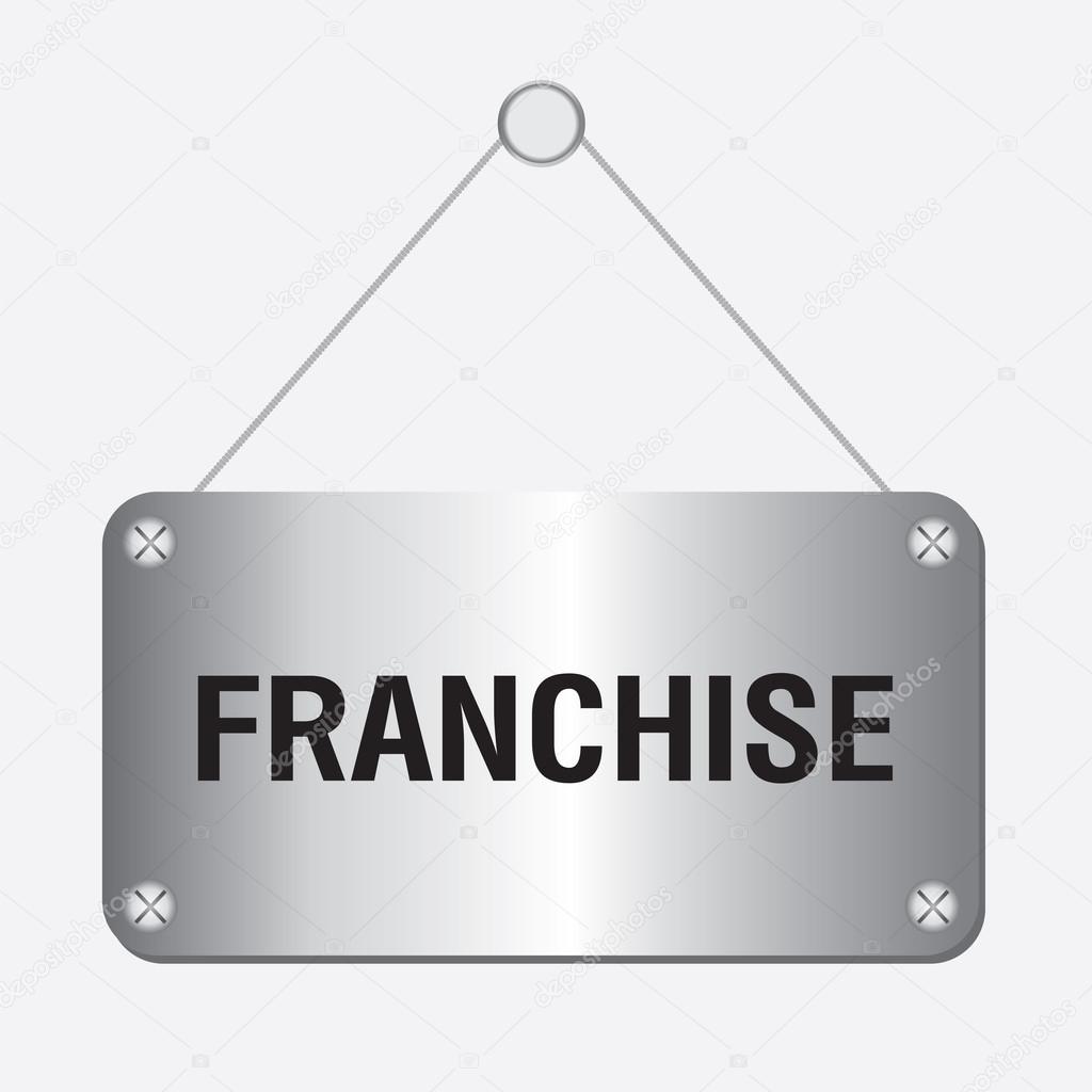 Silver metallic franchise sign hanging on the wall