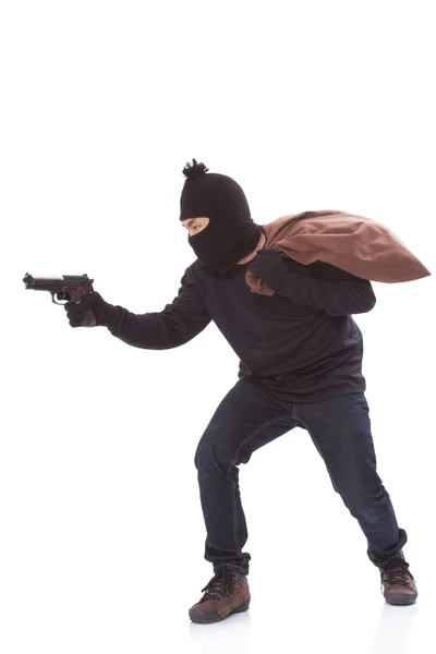 Bandit holding gun with bag on white background — Stock Photo, Image