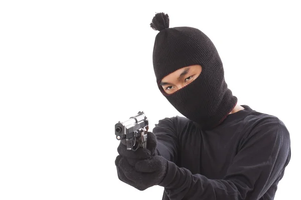 Man in een masker met een kanon op een witte achtergrond — Stockfoto