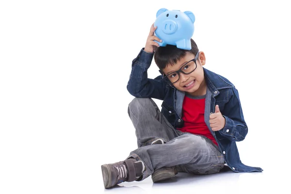 Pequeno menino com porquinho banco — Fotografia de Stock