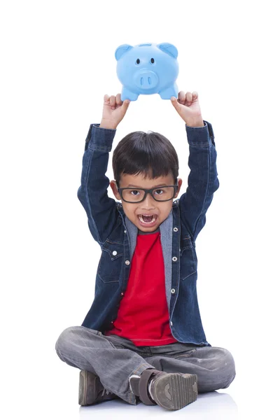 Pequeno menino com porquinho banco — Fotografia de Stock