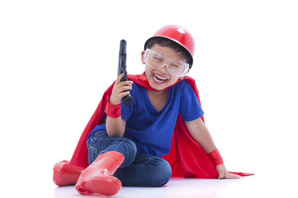 Child pretending to be a superhero with toy gun on white background