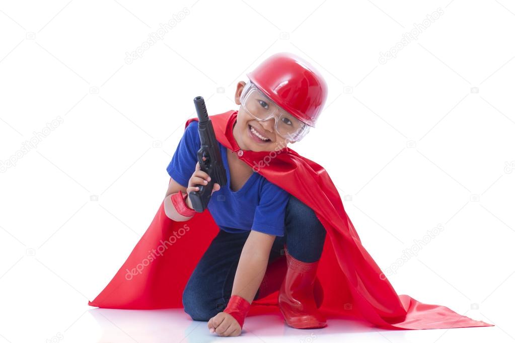 Child pretending to be a superhero with toy gun on white background