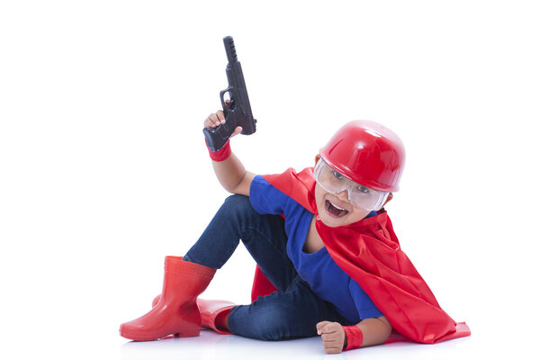 Child pretending to be a superhero with toy gun on white background