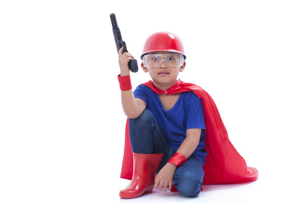 Child pretending to be a superhero with toy gun on white background