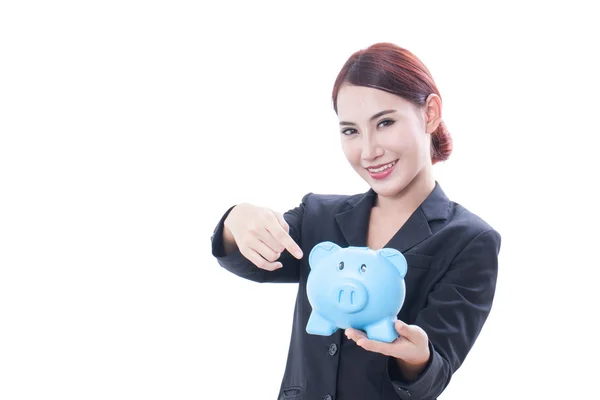 Happy businesswoman pointing at piggy bank — Stock Photo, Image