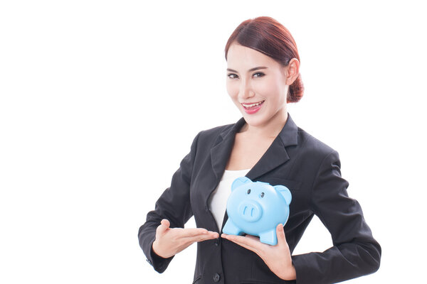 Smiling businesswoman holding piggy bank