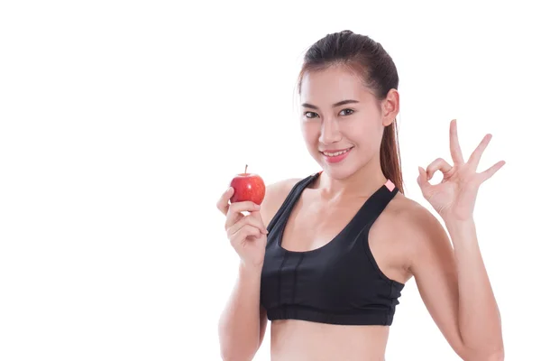 Elma basılı tutup ok işaret gösteren fitness kadın — Stok fotoğraf