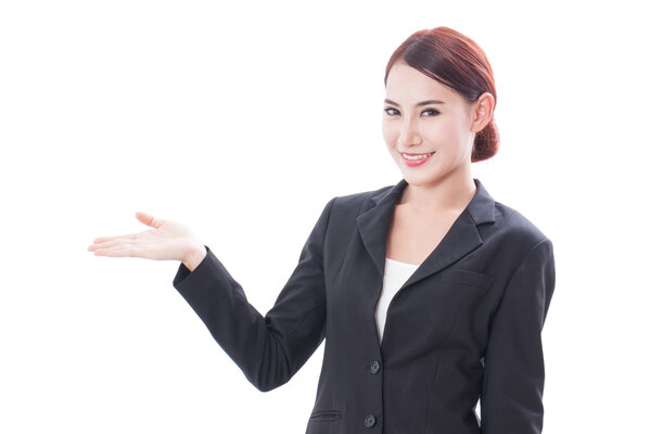 Smiling young businesswoman showing blank area for sign or copyspase